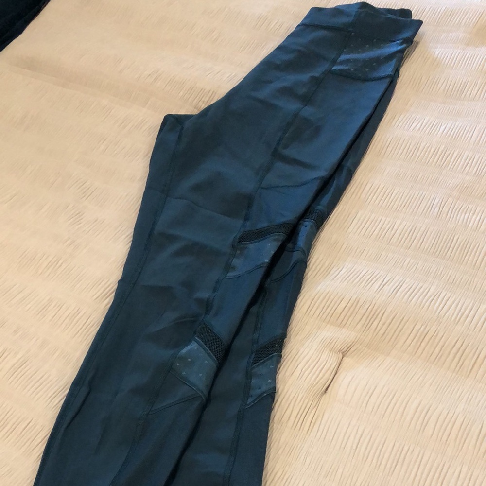 Dark teal/jewel tone Lululemon leggings with mesh detail